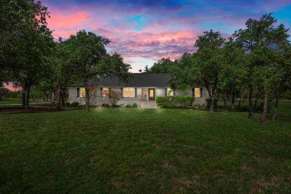 a front view of a house with a garden