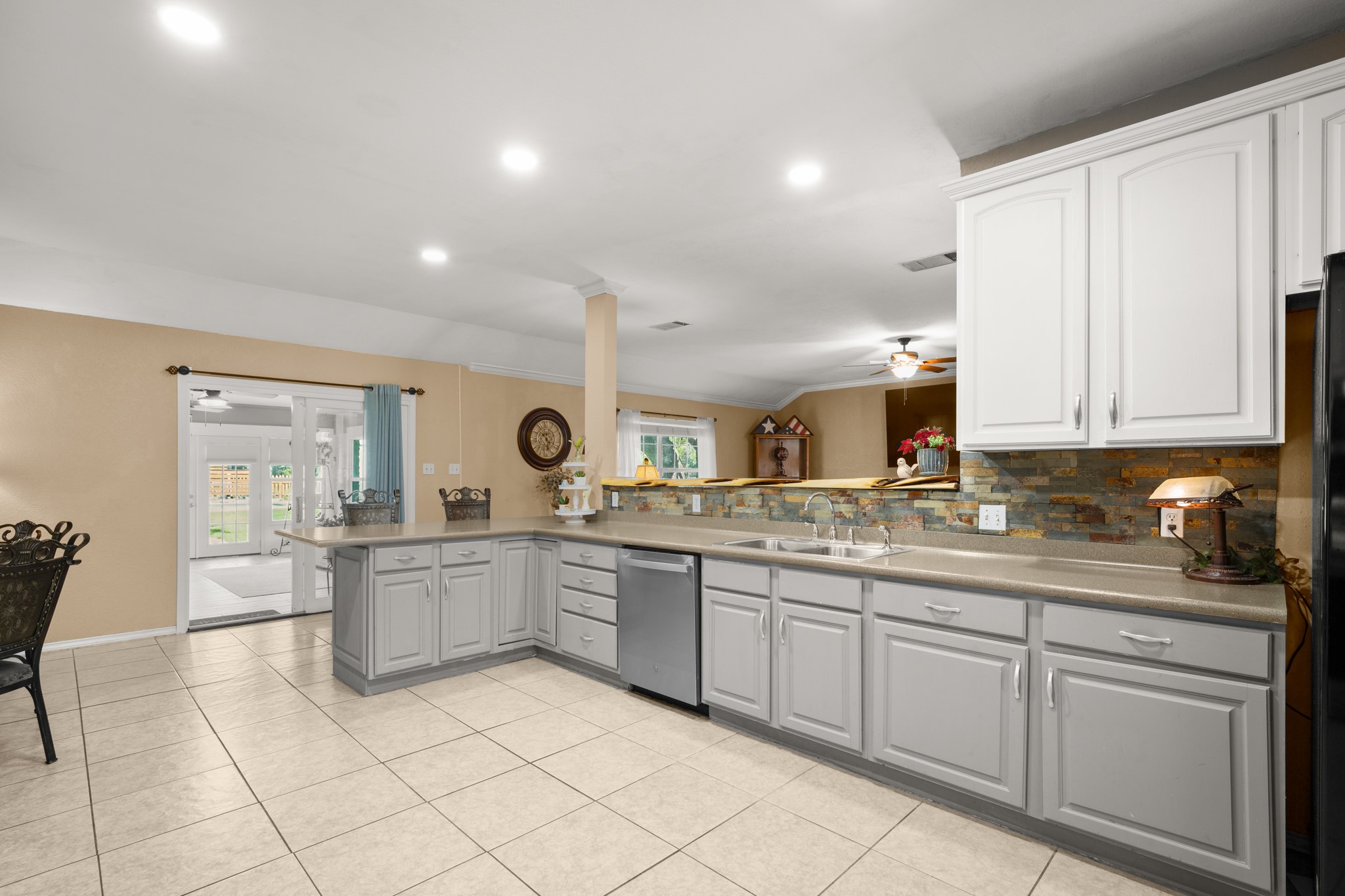 350 Lost River Road Georgetown, TX 78628 - Photo 8 of 39 Fit your resident chef; your kitchen features a peninsula breakfast bar, a breakfast area, a backsplash, a built-in microwave, an electric range, and a pantry.