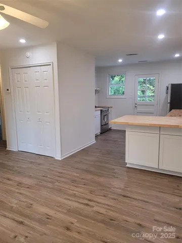 a view of a kitchen with furniture and a wooden floor