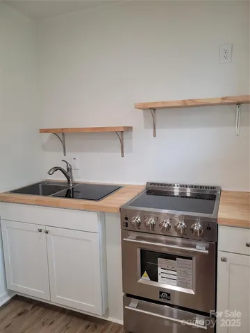 a stove top oven sitting inside of a kitchen