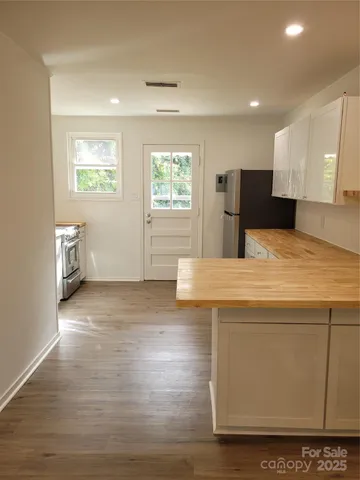 a kitchen with stainless steel appliances a refrigerator sink and microwave