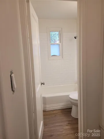 a bathroom with a toilet a sink and bathtub