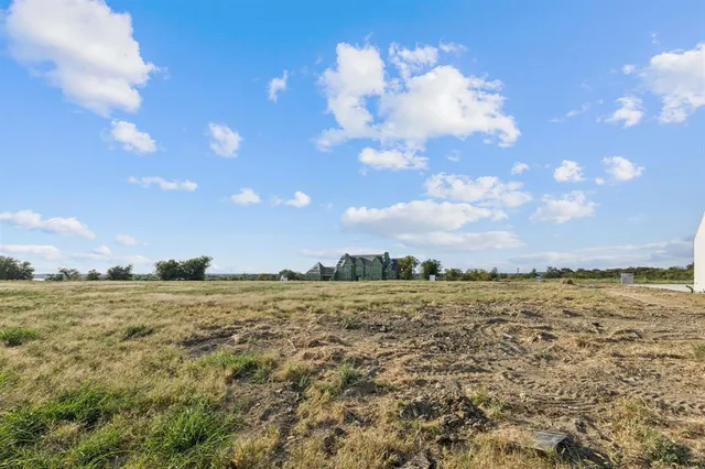 a view of a road with big yard