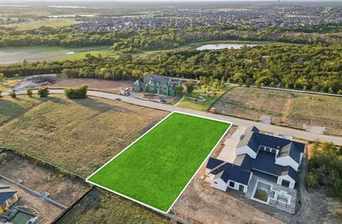 an aerial view of a house with a garden and lake view