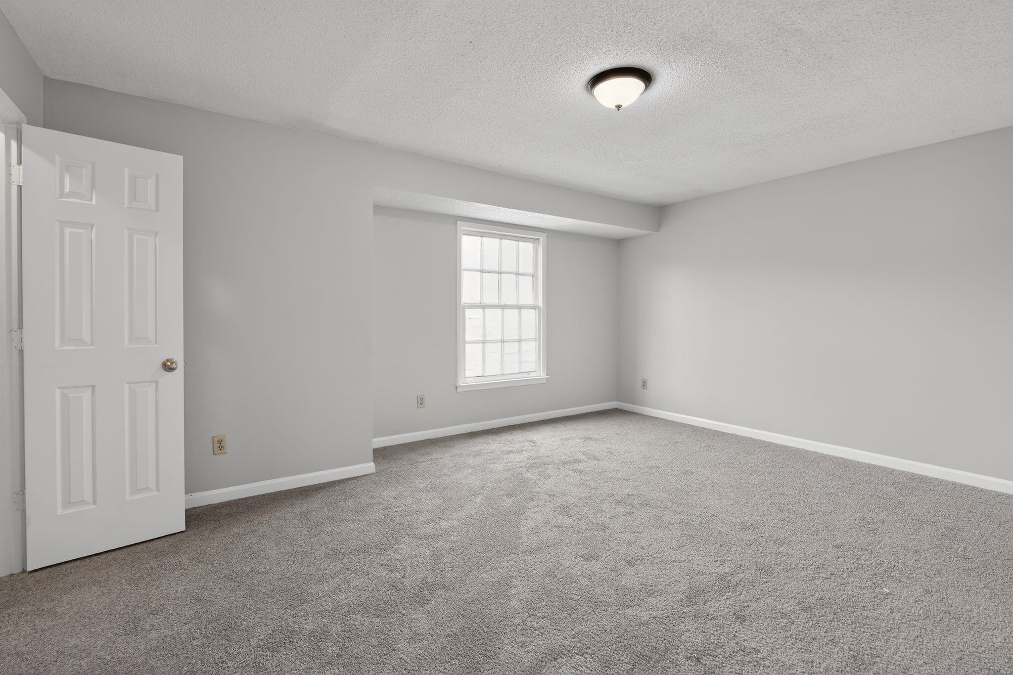5581 Crepe Myrtle Drive Memphis, TN 38115 - Photo 11 of 33 Carpeted empty room with a textured ceiling and baseboards