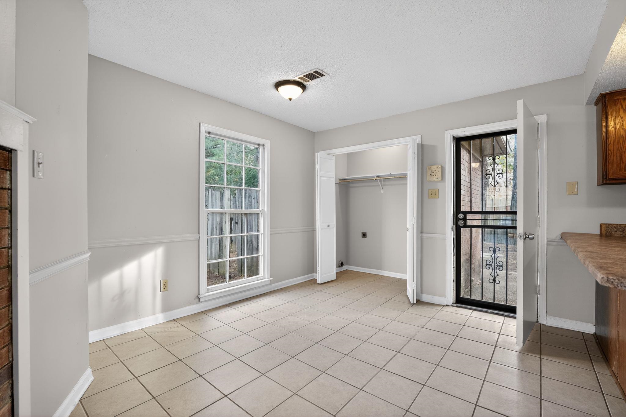 5581 Crepe Myrtle Drive Memphis, TN 38115 - Photo 20 of 33 Unfurnished dining area with a textured ceiling, light tile patterned flooring, and healthy amount of natural light