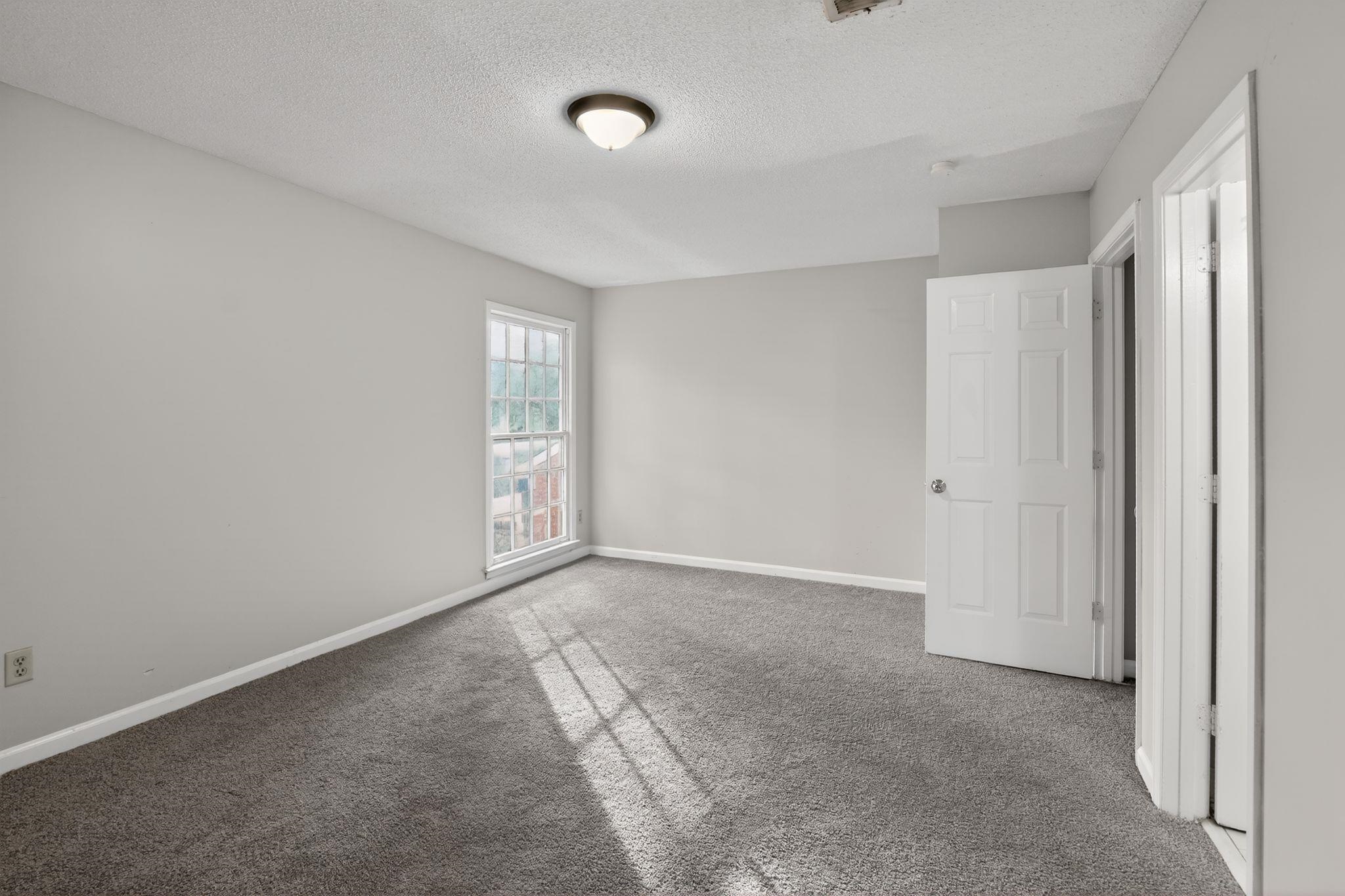 5581 Crepe Myrtle Drive Memphis, TN 38115 - Photo 24 of 33 Unfurnished bedroom featuring a textured ceiling and carpet