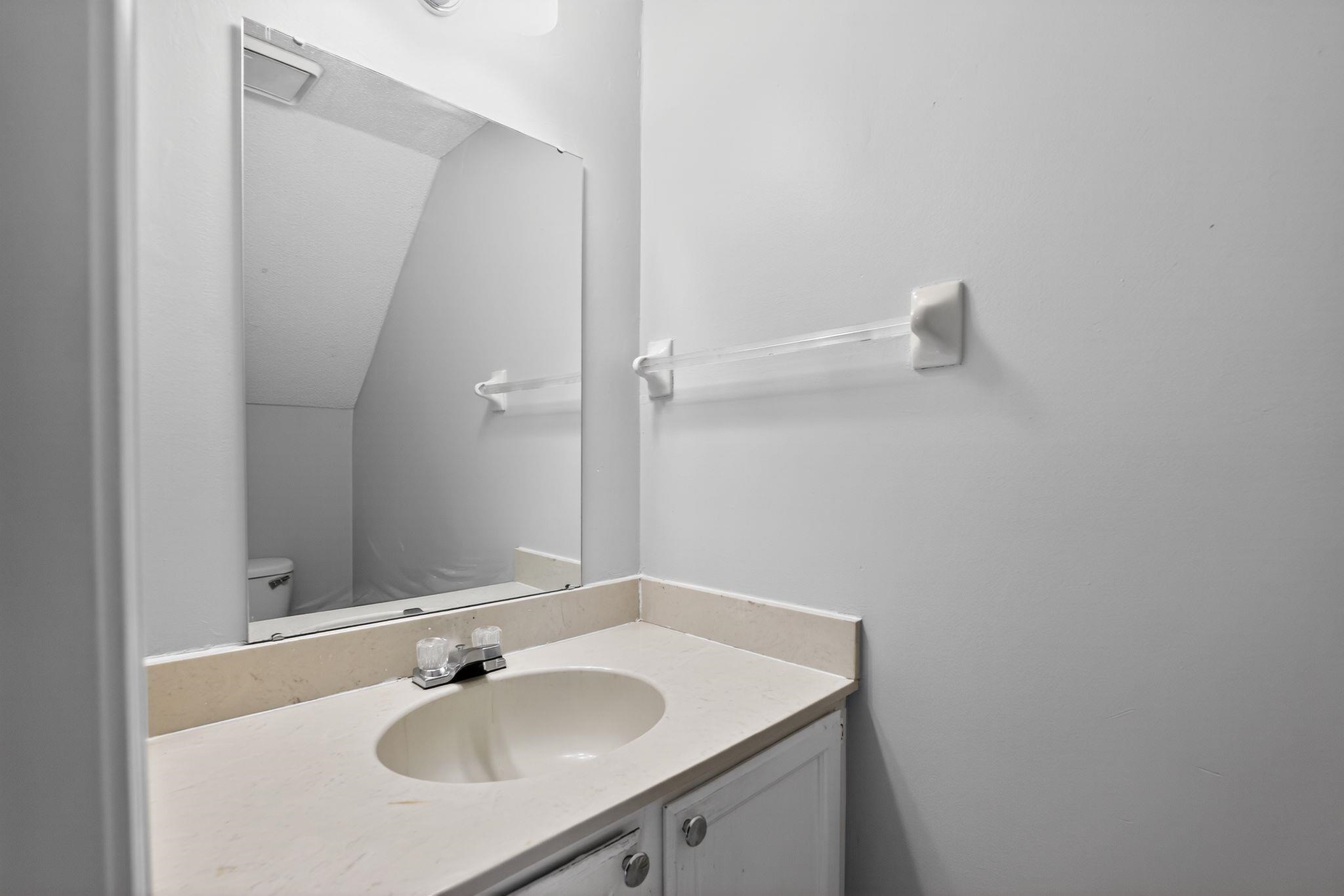 5581 Crepe Myrtle Drive Memphis, TN 38115 - Photo 26 of 33 Half bathroom with vanity and vaulted ceiling