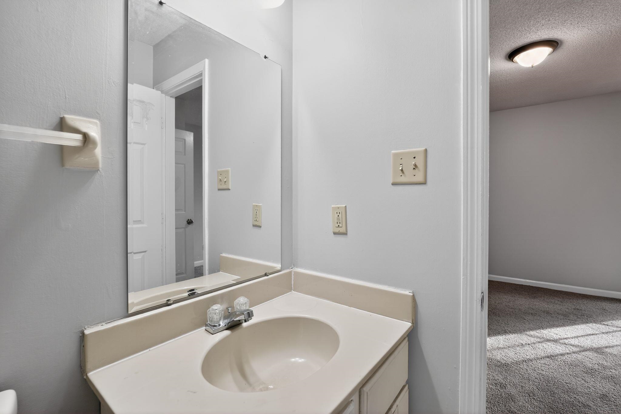 5581 Crepe Myrtle Drive Memphis, TN 38115 - Photo 29 of 33 Half bathroom with vanity, carpet floors, and a textured ceiling
