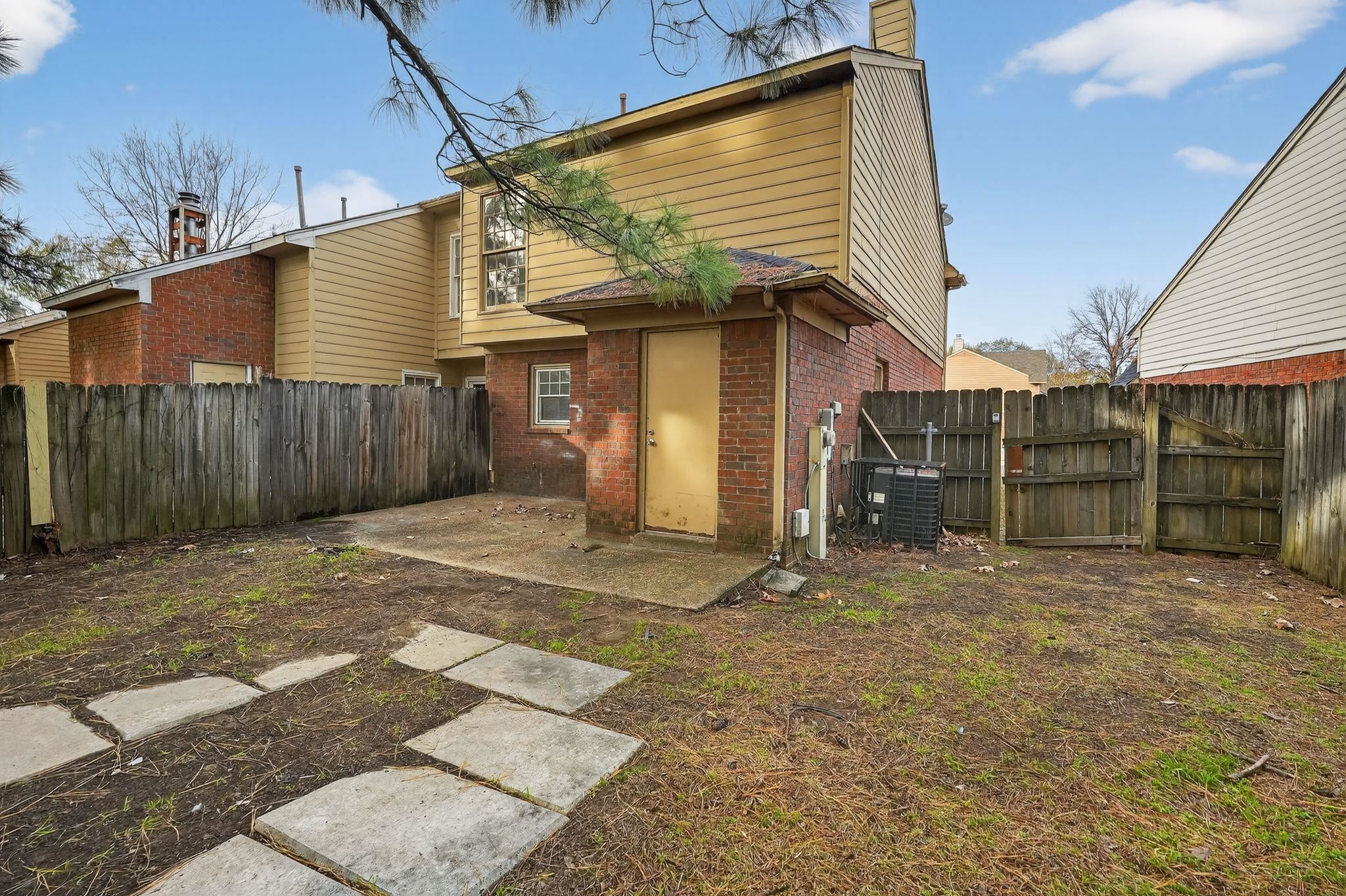 5581 Crepe Myrtle Drive Memphis, TN 38115 - Photo 5 of 33 Rear view of property with a chimney, brick siding, a fenced backyard, and a patio area