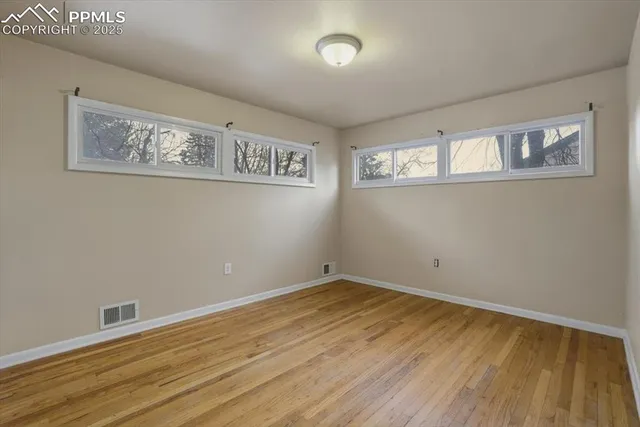 a view of a room with wooden floor