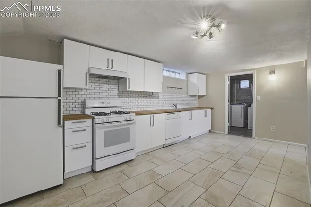 a kitchen with a stove a sink and a refrigerator