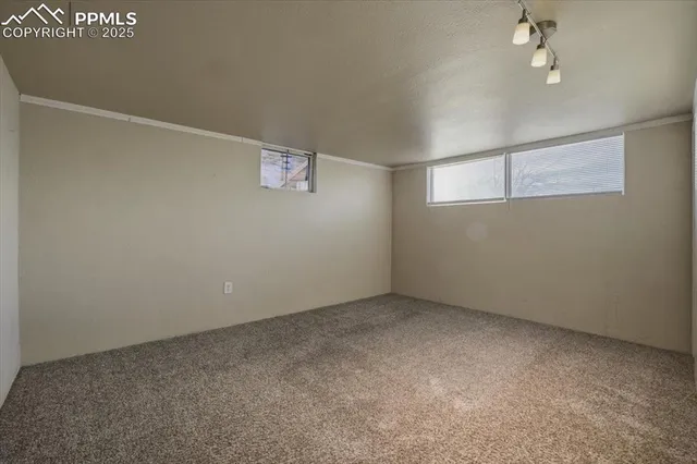an empty room with a ceiling fan and window