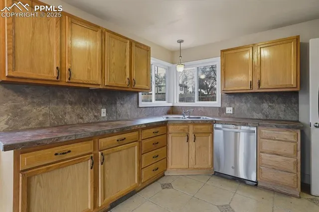 a kitchen with cabinets appliances and a window