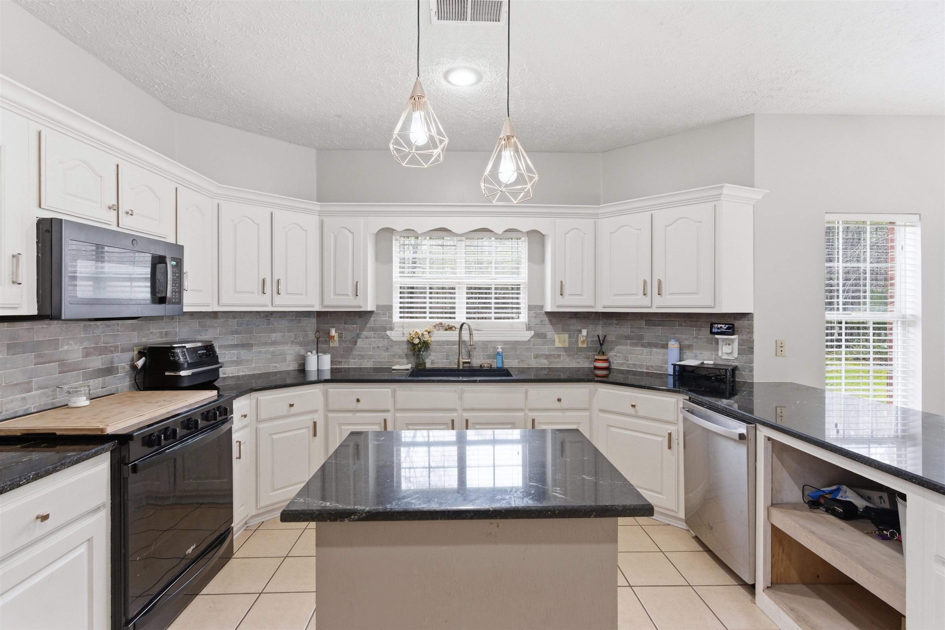 915 Cliffview Road Bolivar, TN 38008 - Photo 12 of 35 Kitchen featuring black range with electric cooktop, white cabinetry, and a textured ceiling