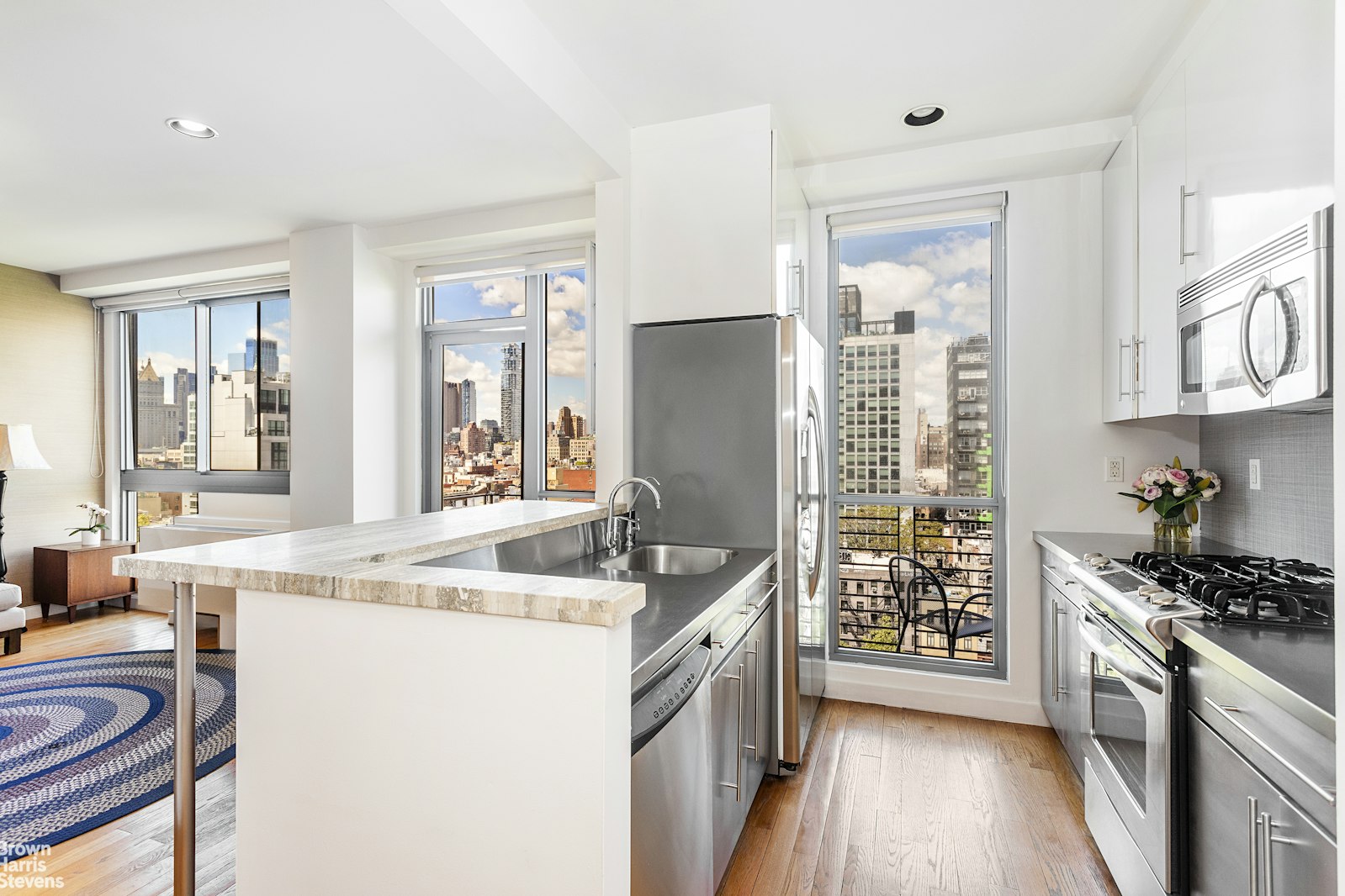38 Delancey Street, Unit 10D Manhattan, NY 10002 - Photo 1 of 14 a kitchen that has a sink a stove and a wooden floor