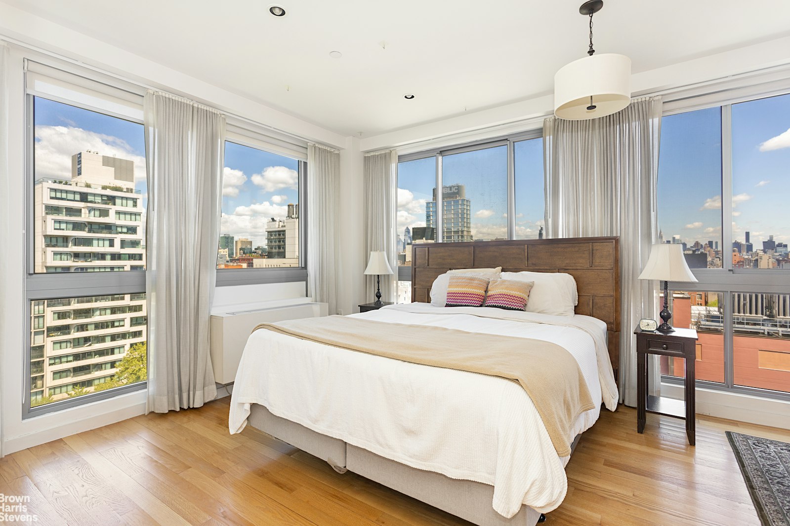 38 Delancey Street, Unit 10D Manhattan, NY 10002 - Photo 4 of 14 a bedroom with a large bed and a chandelier