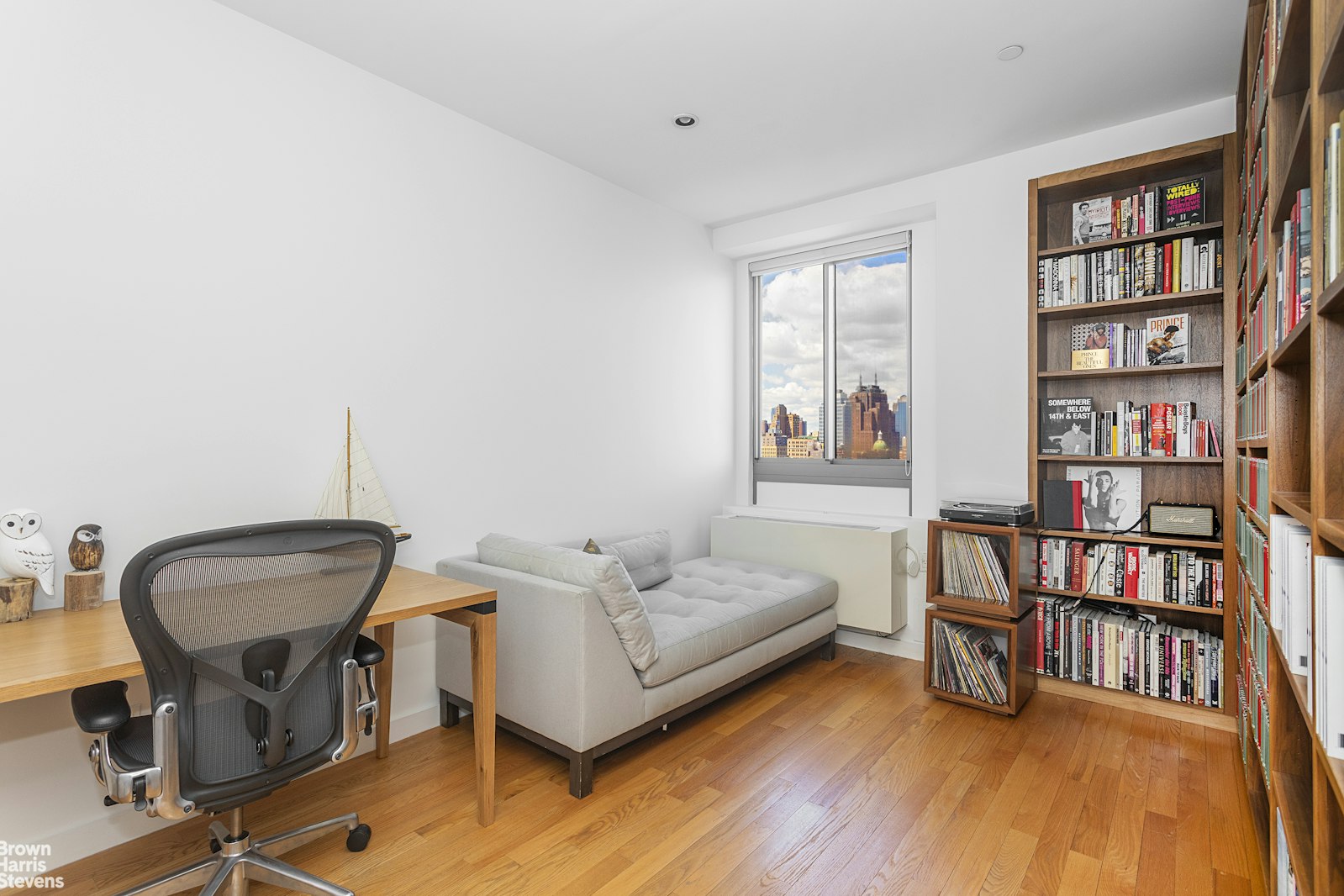 38 Delancey Street, Unit 10D Manhattan, NY 10002 - Photo 6 of 14 a living room with furniture and a book shelf