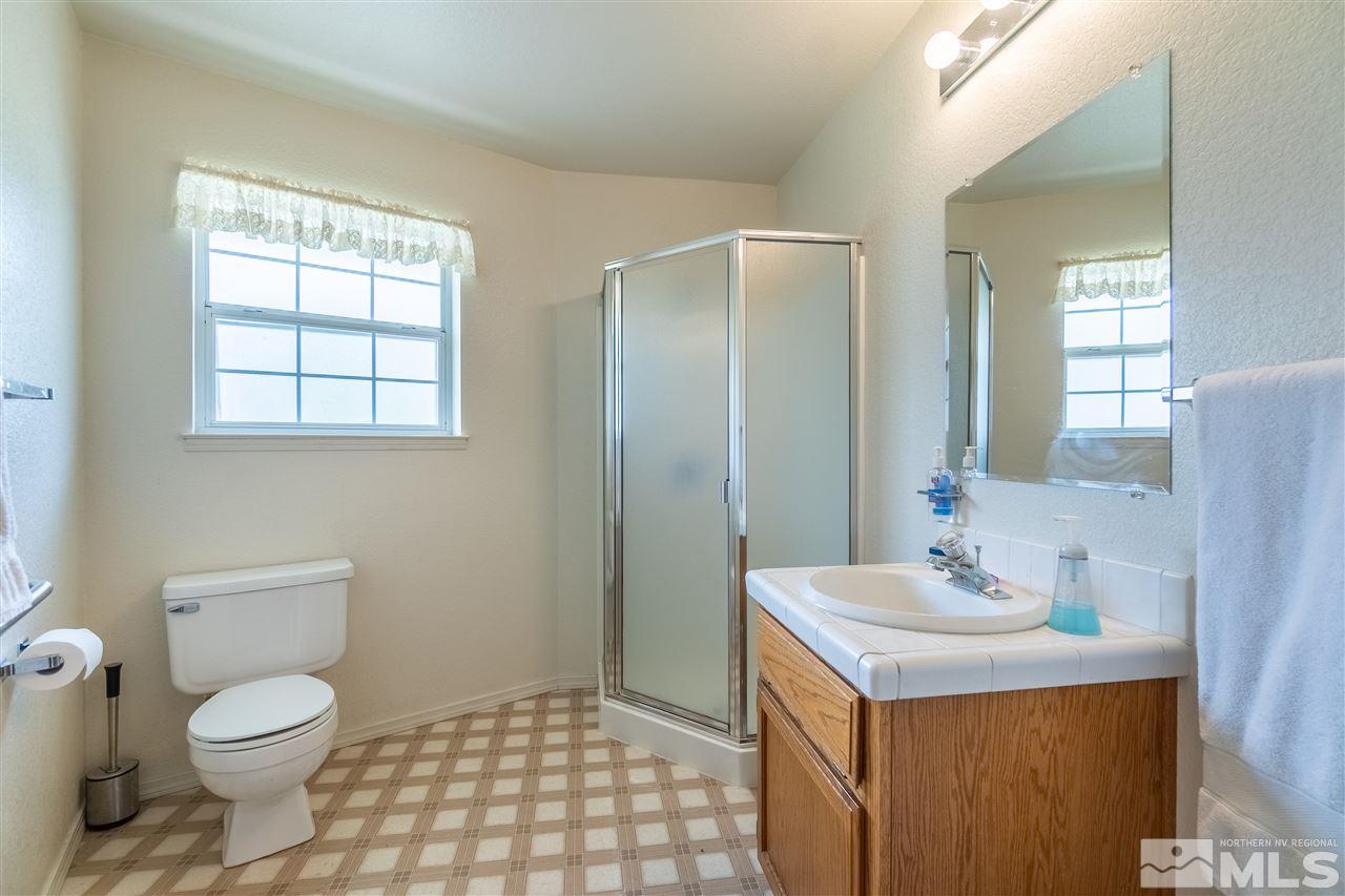 761 Rubio Way Gardnerville, NV 89460 - Photo 11 of 30 a bathroom with a sink a toilet and window