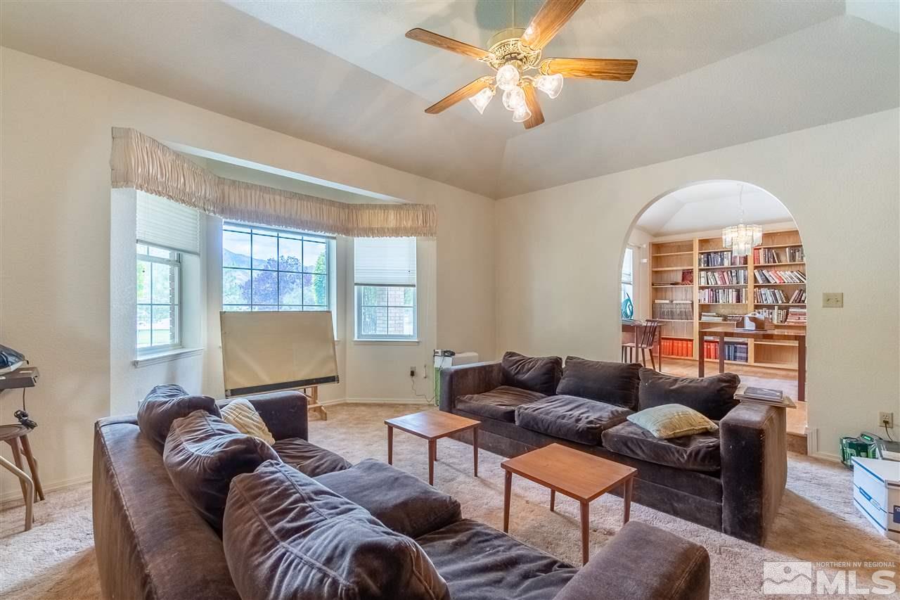 761 Rubio Way Gardnerville, NV 89460 - Photo 16 of 30 a living room with furniture a chandelier and a window