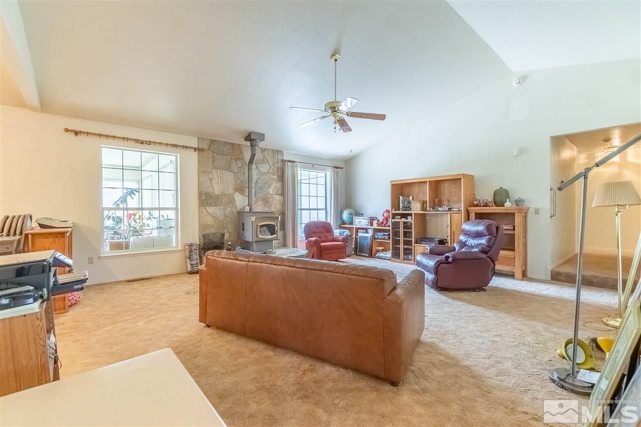 761 Rubio Way Gardnerville, NV 89460 - Photo 19 of 30 a living room with furniture a fireplace and a flat screen tv