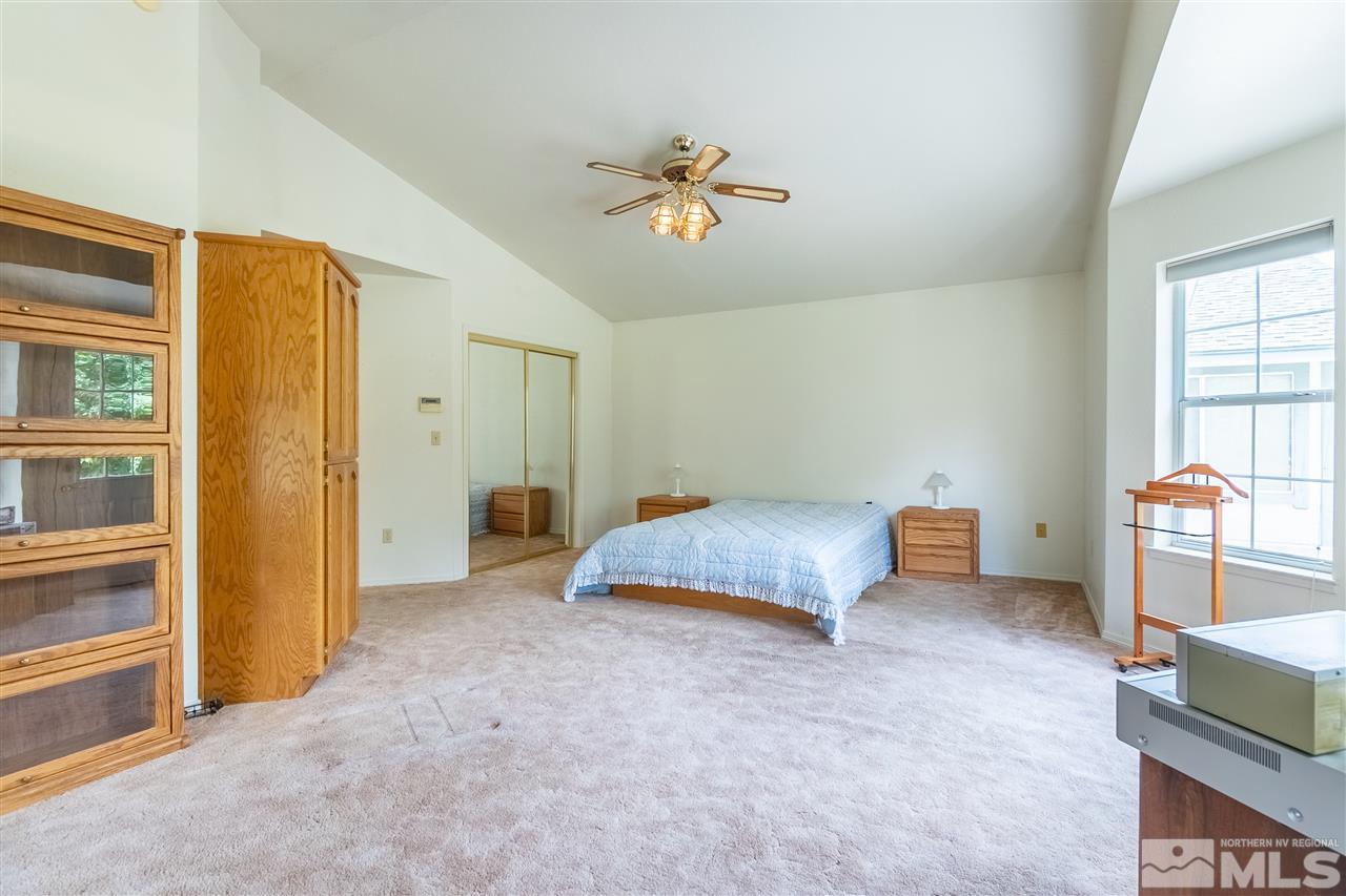 761 Rubio Way Gardnerville, NV 89460 - Photo 24 of 30 a bedroom with a bed and a chandelier