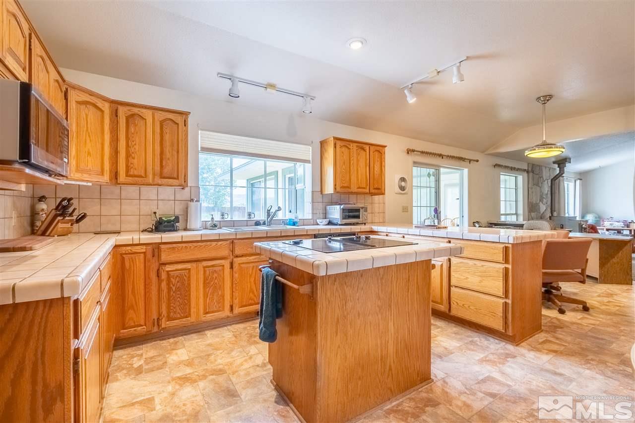 761 Rubio Way Gardnerville, NV 89460 - Photo 10 of 30 a kitchen with stainless steel appliances granite countertop a stove and a sink