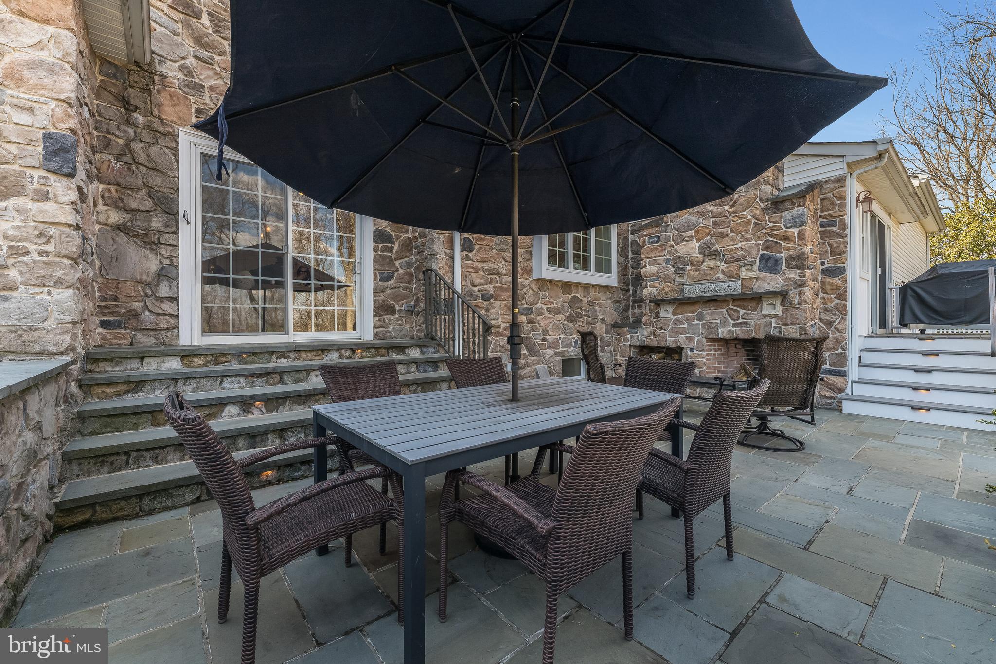 27 Milestone Drive Ringoes, NJ 08551 - Photo 55 of 75 a view of a roof deck with table and chairs under an umbrella