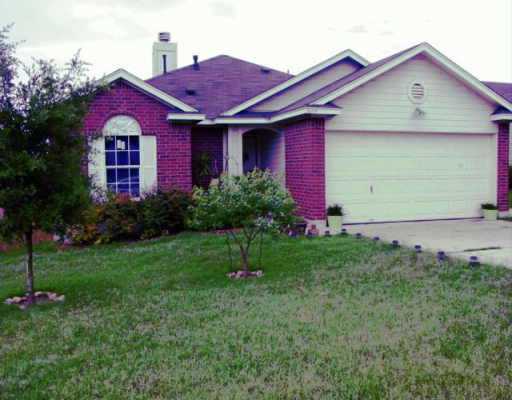 5609 China Berry Road Austin, TX 78744 - Photo 1 of 1 a front view of a house with garden