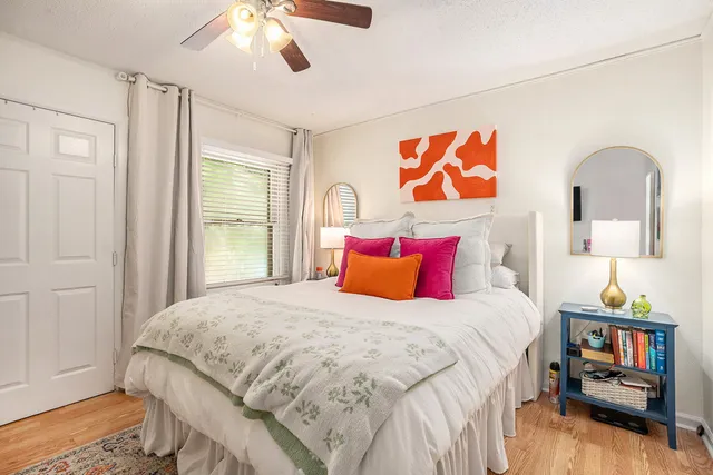 a bedroom with a large bed and a window