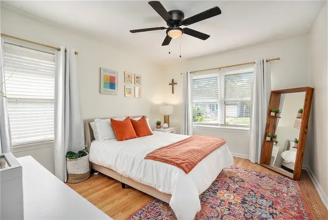 a workspace with furniture a window and a ceiling fan