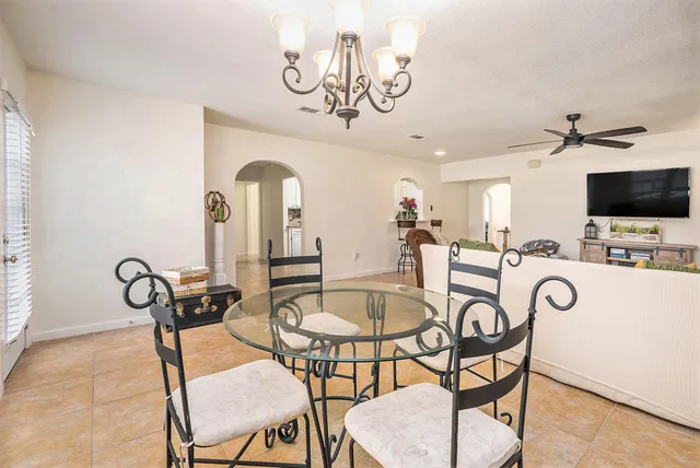 a view of a room with furniture and a chandelier