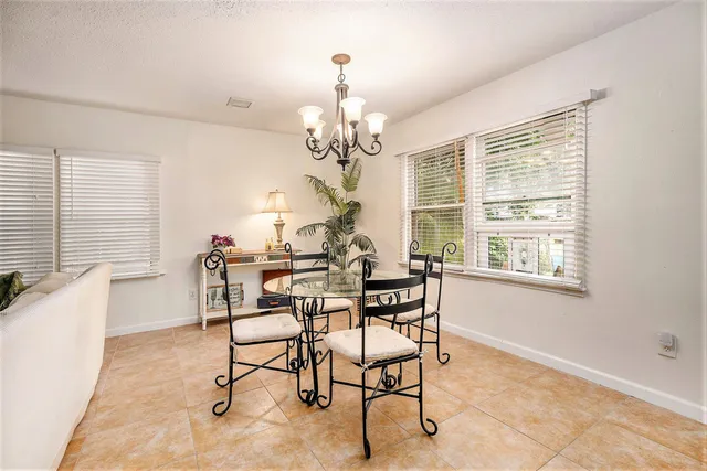 a view of a dining room with furniture and a chandelier