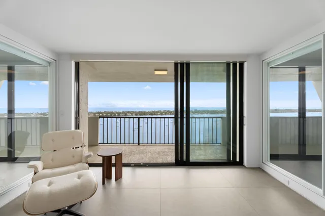 a view of a livingroom with furniture and a large window