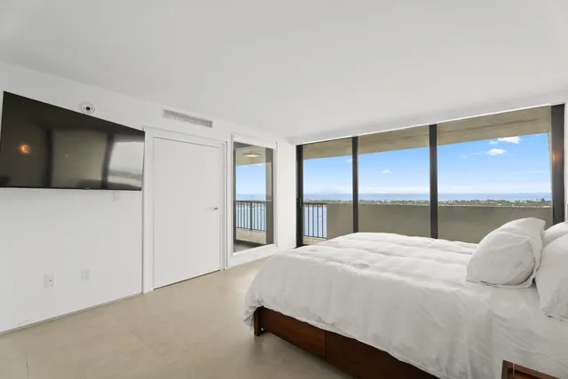 a bedroom with a large bed and a large window