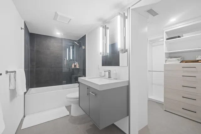 a bathroom with a bathtub a shower a sink and mirror