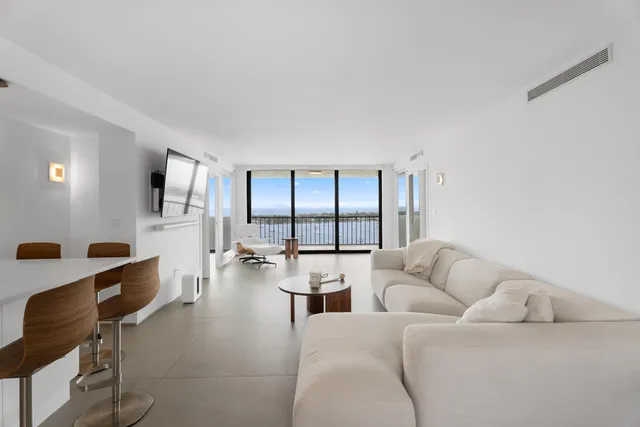 a living room with furniture and large windows