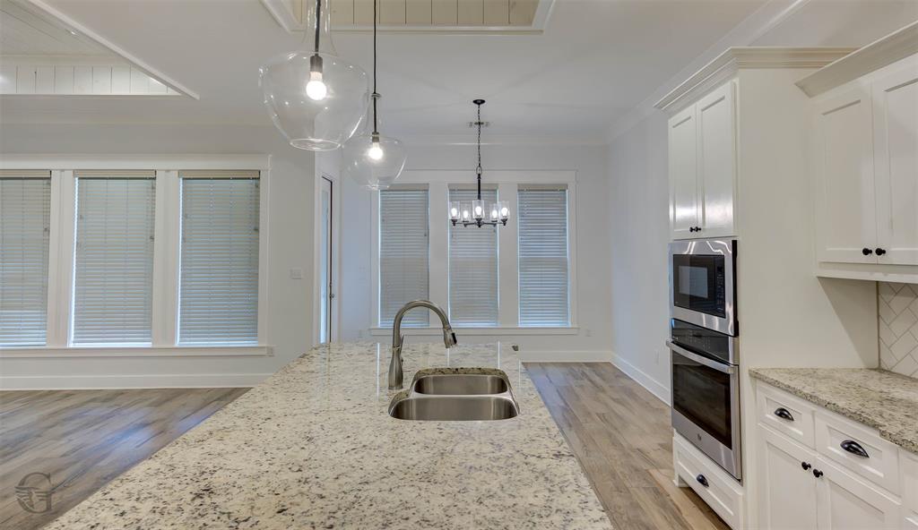 605 Meridian Way Benton, LA 71006 - Photo 10 of 29 Kitchen island featuring a double basin stainless steel sink with a gooseneck faucet