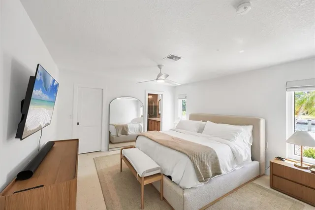 a bathroom with a sink a toilet a mirror and shower