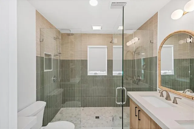 a bedroom with two beds and a large window