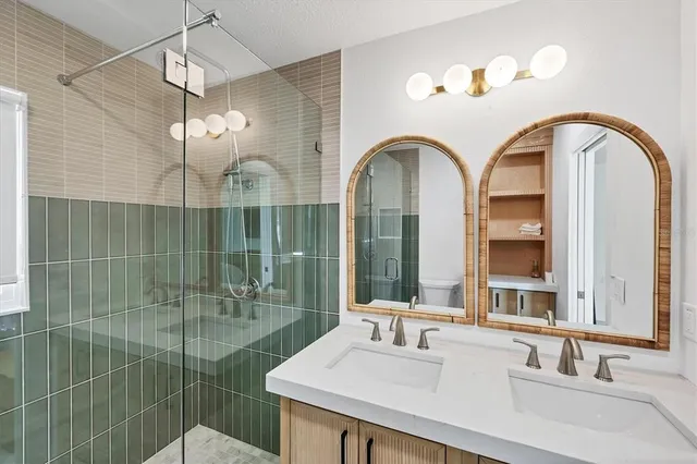 a bedroom with two bed and a lamp with wooden floor