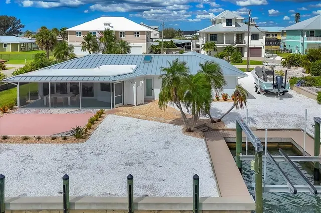 a view of a lake with a table and chairs