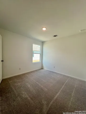 an empty room with a empty space and windows