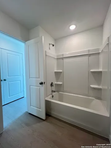 a kitchen with stainless steel appliances and white cabinets