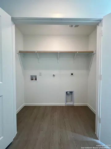 a kitchen with kitchen island a sink a stove and cabinets