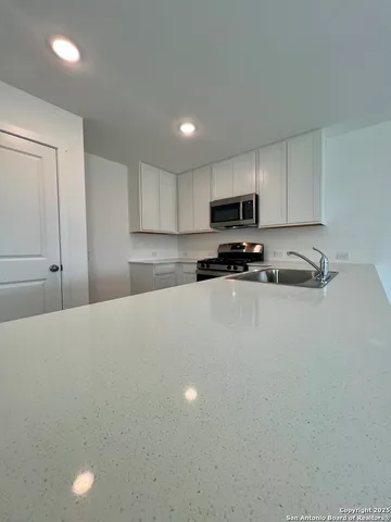 a bedroom with a bed and a sink