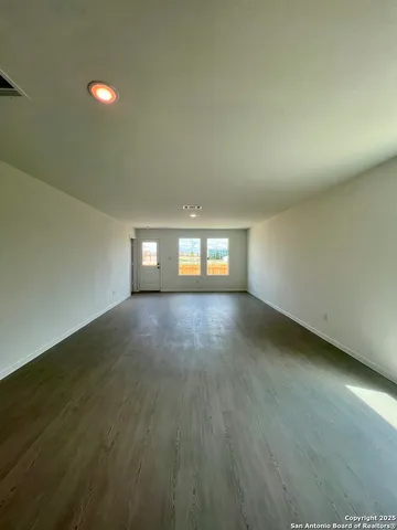 an empty room with wooden floor