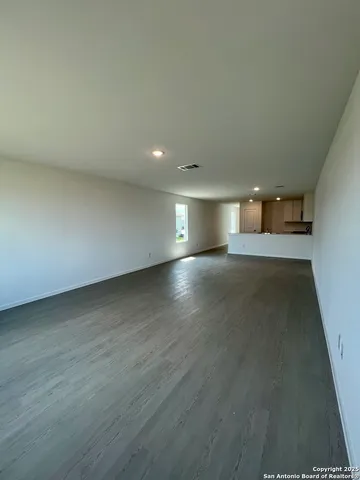 an empty room with a empty space and windows