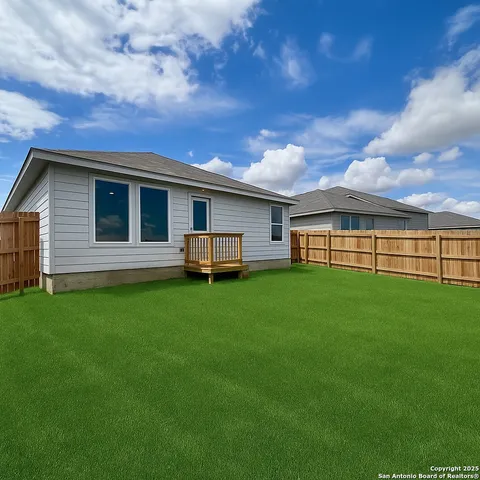 a view of a patio with dining table and chairs