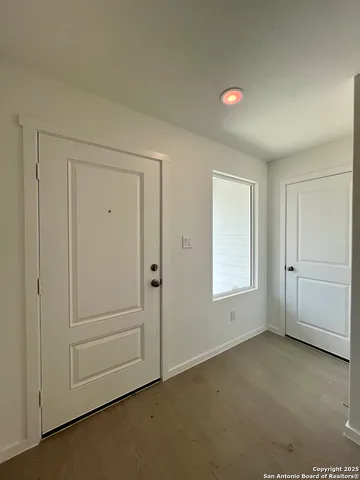 an empty room with windows and closet